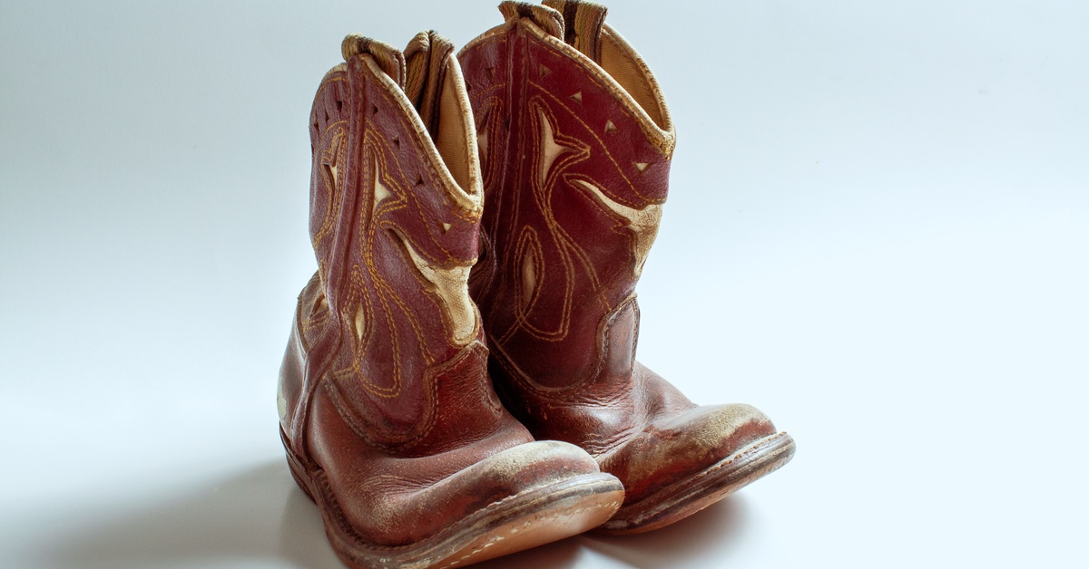 A black plastic box with multiple threaded holes punched into each of its sides. The box sits on a paper diagram.