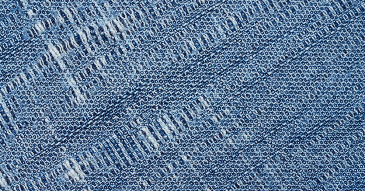An extreme close-up on a piece of denim fabric; you can see the twill weave patten used to create it.
