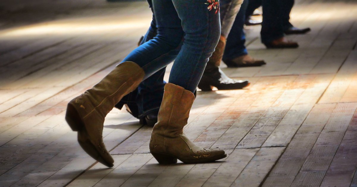 Why Cowgirl Jeans Remain Popular Across Generations Several people wearing jeans and boots moving across a wooden dance floor, shown from the waist down.
